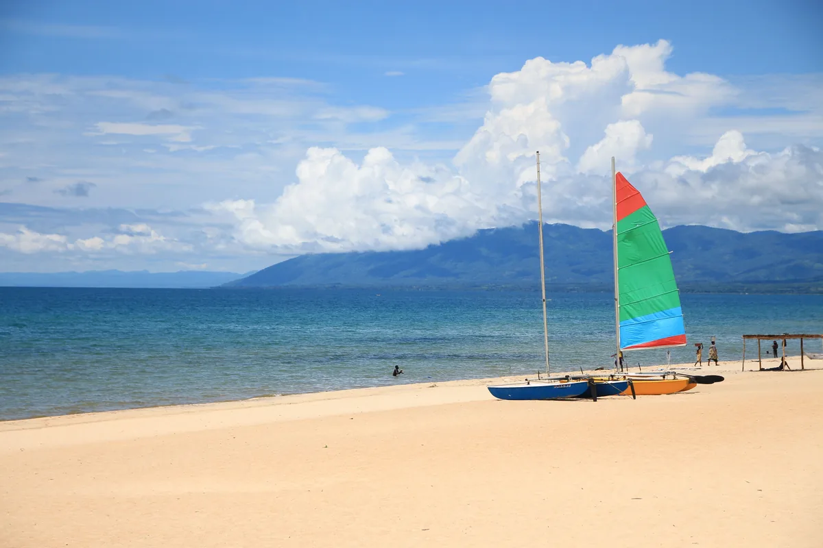 Fishermen's sailing boats on a beach of Lake Malawi, mountains in the background